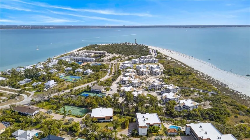 Aerial view of residential area featuring a nearby body of water