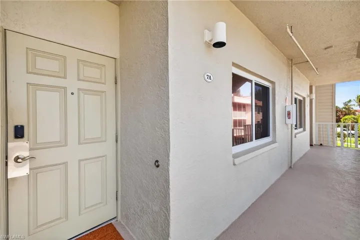 Property entrance featuring stucco siding