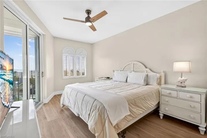 Primary Bedroom featuring light wood finished floors, access to outside, and a ceiling fan