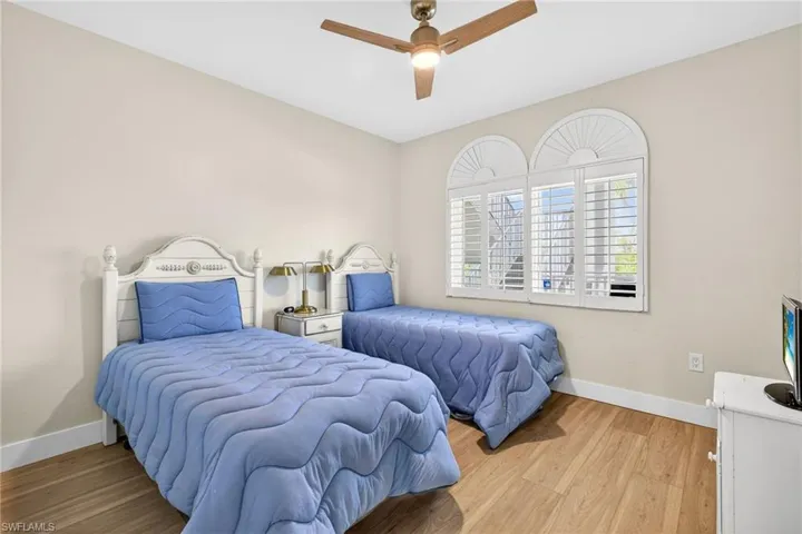 Bedroom with light wood-style flooring and a ceiling fan