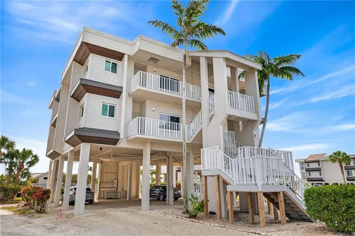 View of apartment building / complex with a carport and driveway