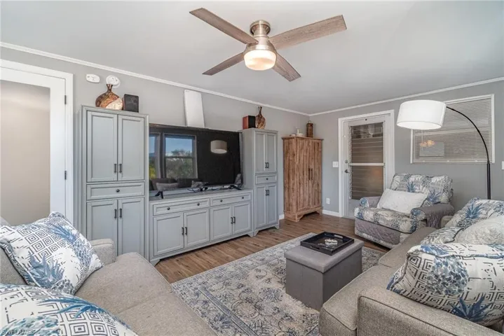 OWNER'S SUITE SITTING ROOM.  DOOR LEADS TO ENCLOSED SCREENED SPACE.