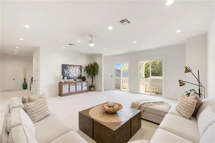 Living room featuring recessed lighting, light carpet, and a ceiling fan