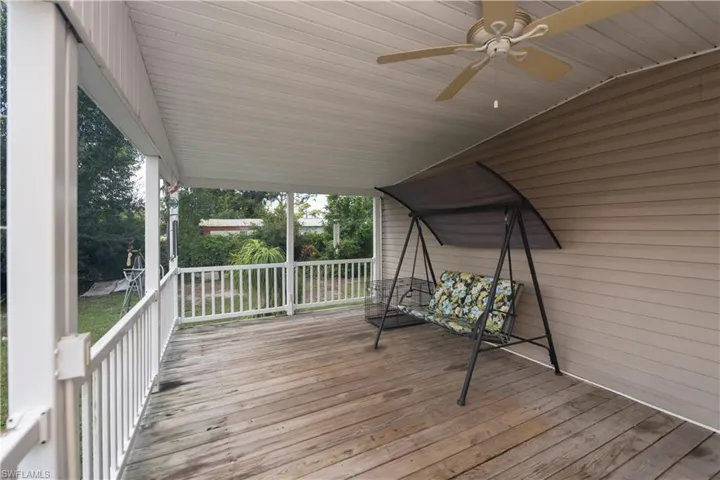 Wooden deck with a porch and ceiling fan