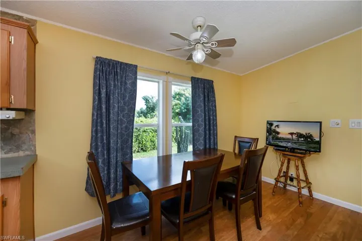 Dining space featuring ornamental molding, ceiling fan, hardwood / wood-style floors, and a textured ceiling