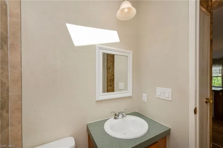 Bathroom featuring a skylight, vanity, and toilet