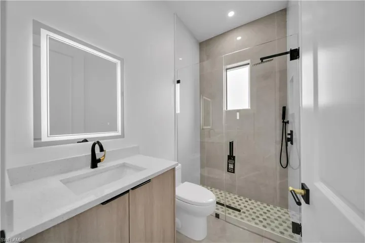Guest  bathroom with vanity, a shower stall, and recessed lighting