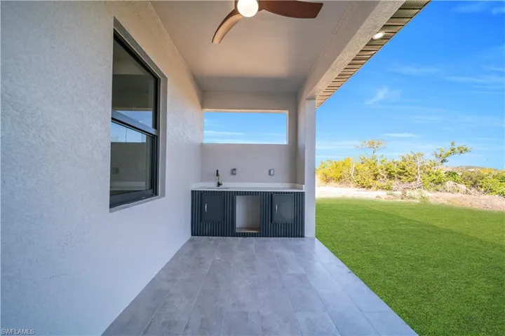 View of patio / terrace featuring a ceiling fan and a sink
