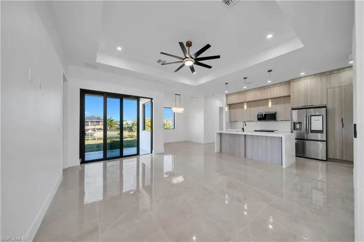 Unfurnished living room featuring a ceiling fan and recessed lighting