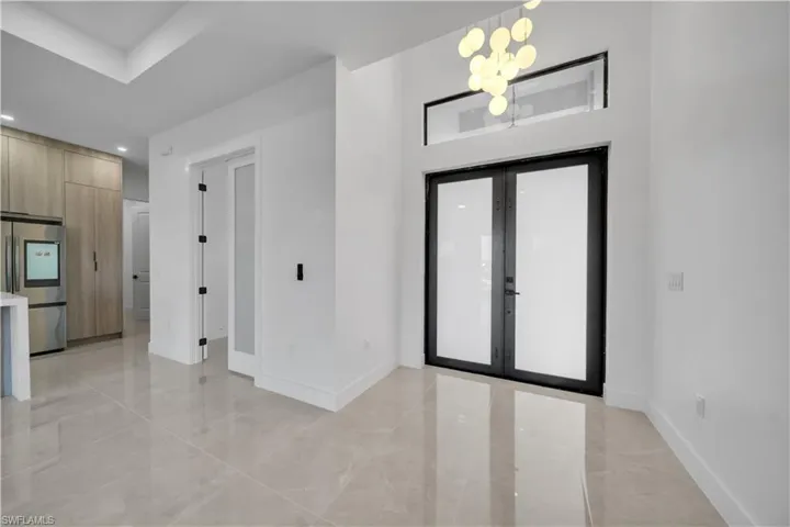 Foyer featuring french doors and a chandelier