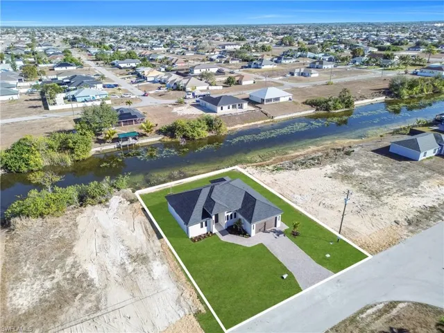 Aerial perspective of suburban area with a nearby body of water