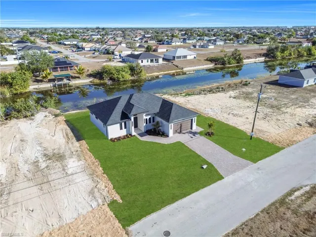 Aerial perspective of suburban area with a nearby body of water