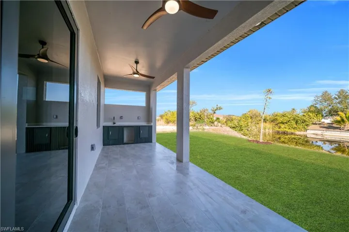 View of patio with ceiling fan and exterior kitchen