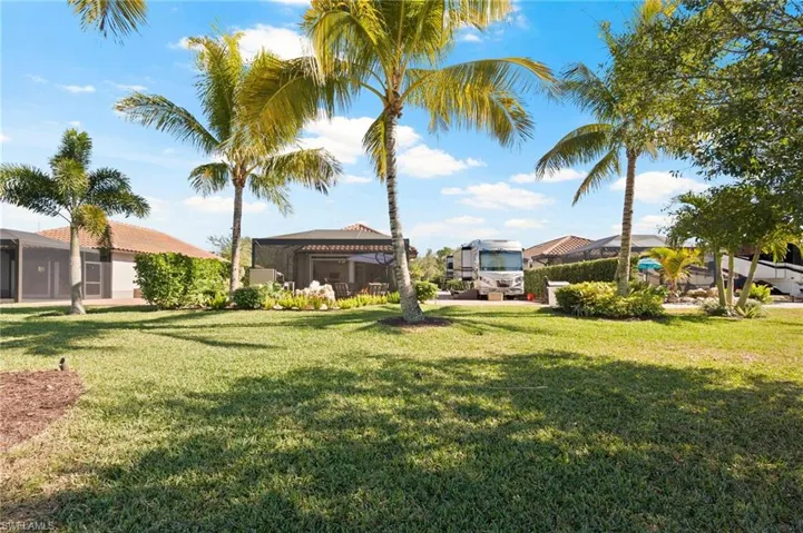 View of green lawn featuring a gazebo and a patio
