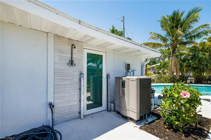 Outdoor shower & glass hurricane impact door w/ flood gate system