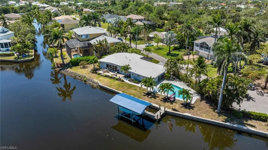 Birds eye view of property with a residential view and a water view