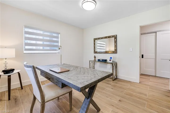 Dining area with light wood-style floors and baseboards