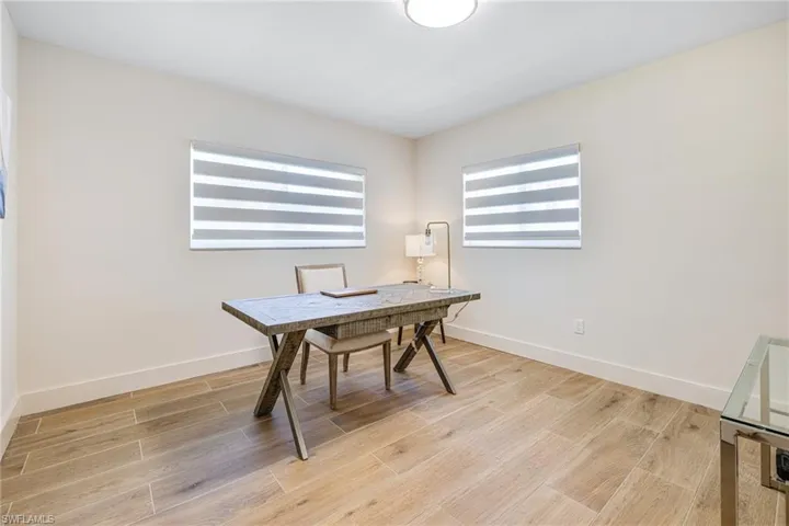 Office space featuring baseboards and light wood-type flooring