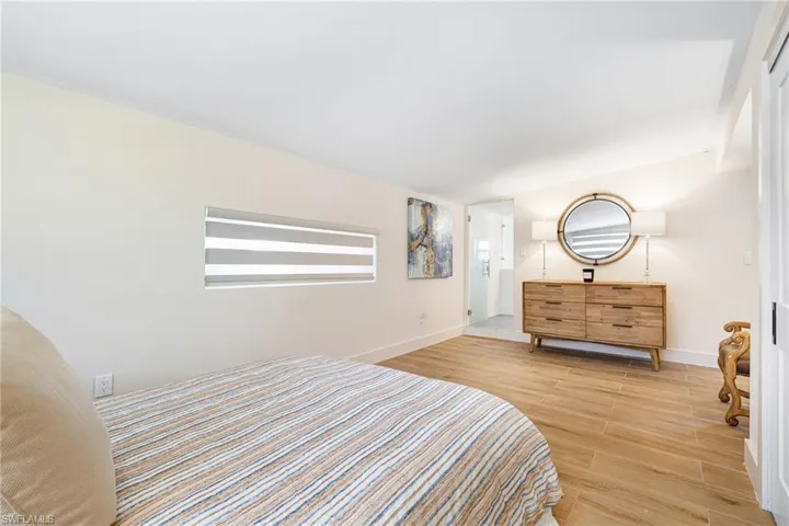 Bedroom with baseboards and wood finished floors