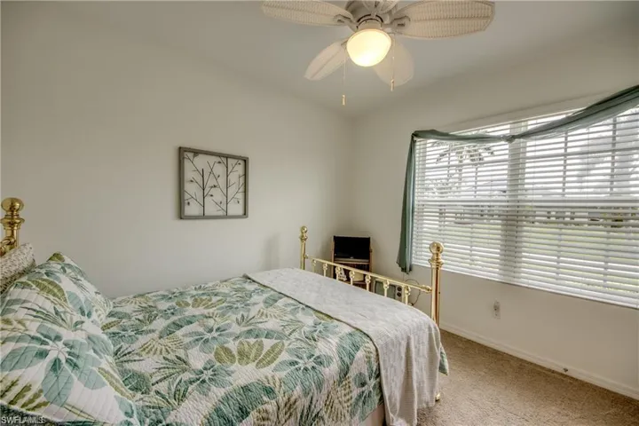 Bedroom featuring carpet, baseboards, and ceiling fan