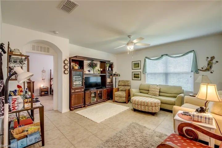 Living room featuring a ceiling fan and light tile patterned floors