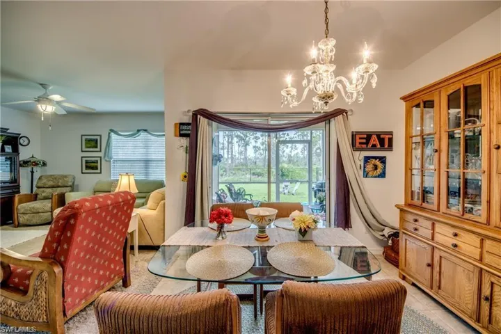 Dining area with a chandelier, a ceiling fan, and light tile patterned flooring