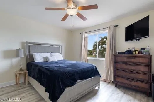 Bedroom featuring light wood finished floors and a ceiling fan