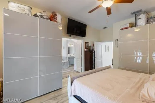 Bedroom with light wood finished floors and a ceiling fan