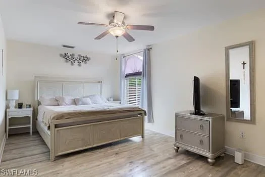 Bedroom with light wood finished floors and ceiling fan