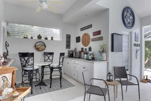 Dining area with a ceiling fan and light tile patterned floors