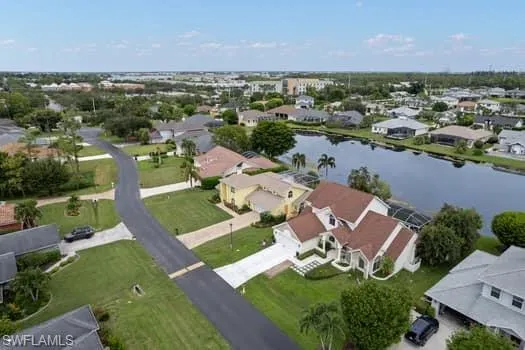 Aerial perspective of suburban area with a nearby body of water