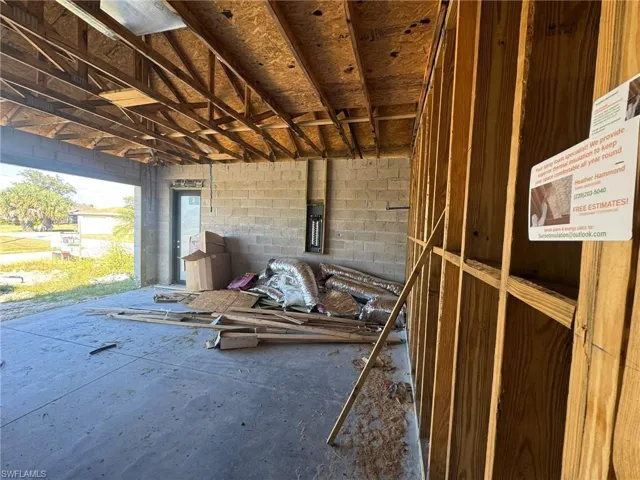 Miscellaneous room featuring concrete block wall