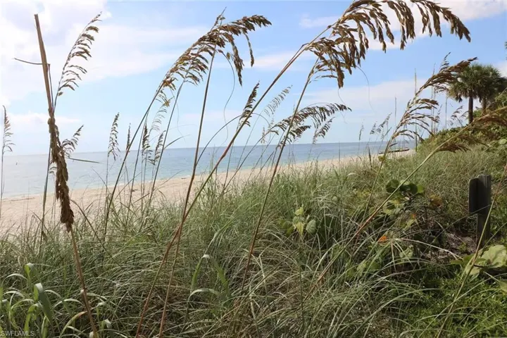 Property view of mountains with a beach view and a water view