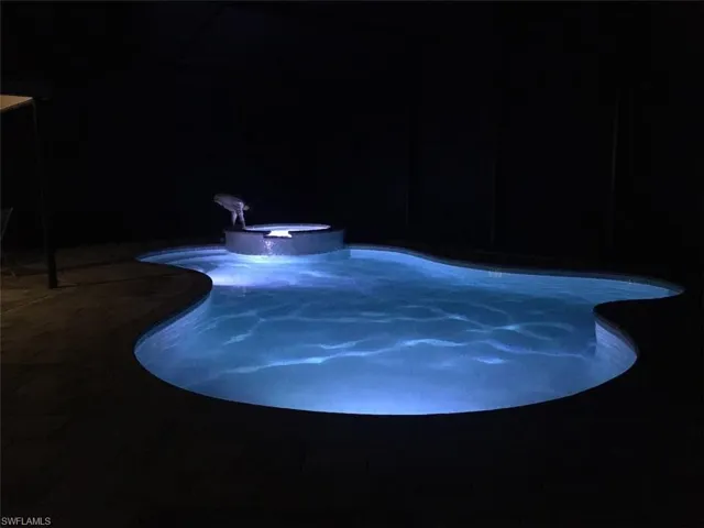 View of swimming pool with a pool with connected hot tub