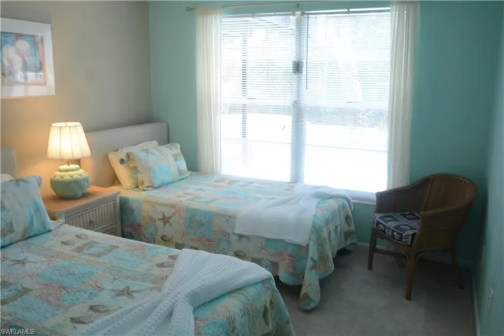 Bedroom with multiple windows and carpet floors