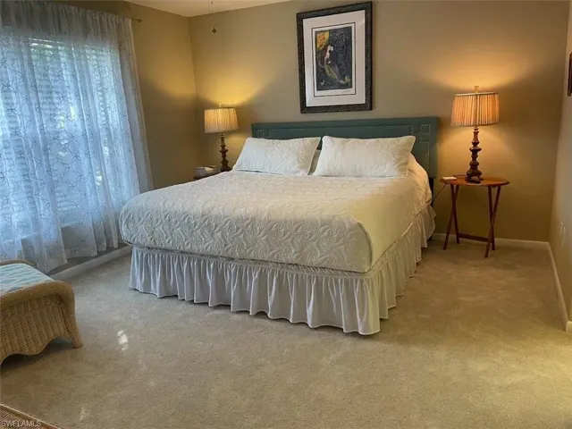 Carpeted bedroom with baseboards