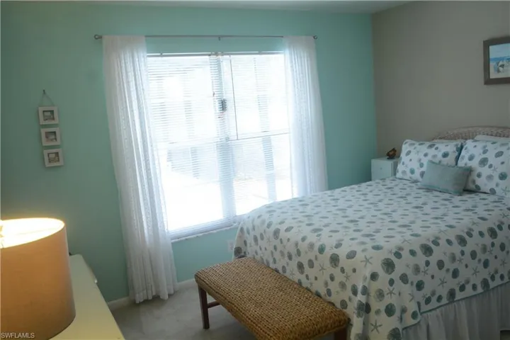 Bedroom featuring light colored carpet and baseboards