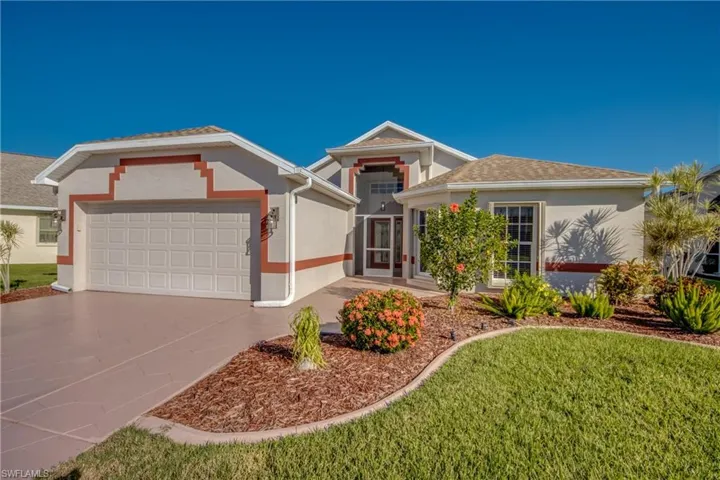 Neatly manicured landscaping with curbing.  Accordion Shutters for ease of hurricane protection.