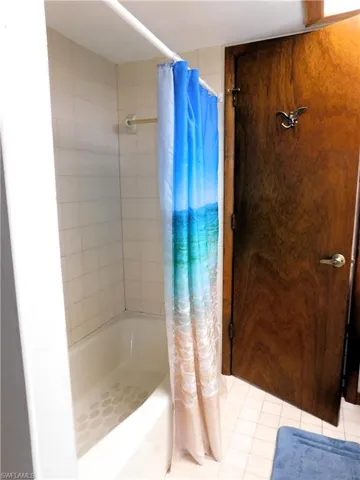 The guest bath features single vanity, combination tub/shower and large linen closet. Also has separate entry to rear yard.