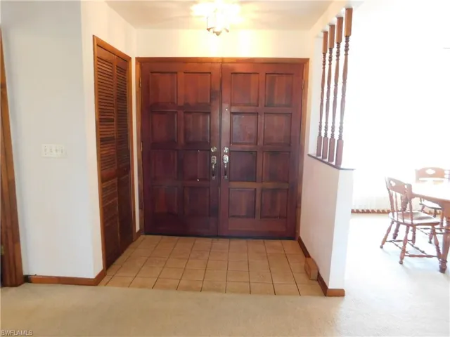 Front entry has double door carved wood doors