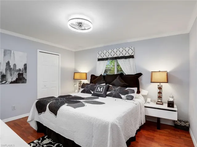 Bedroom with laminate wood flooring and a WIC