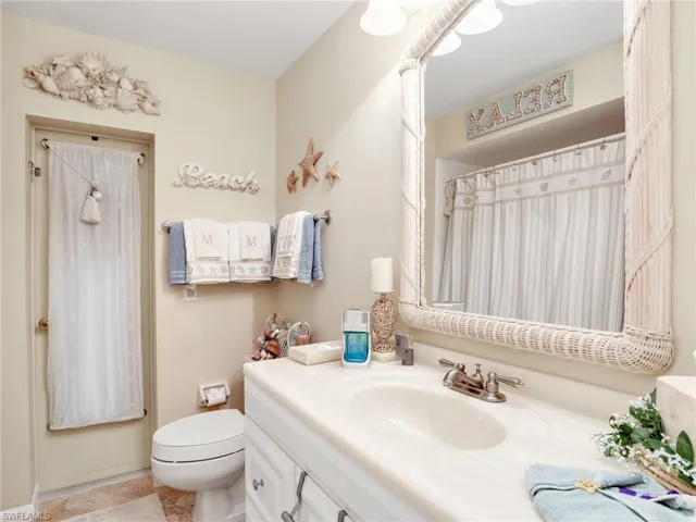 Guest bathroom with door to the pool area