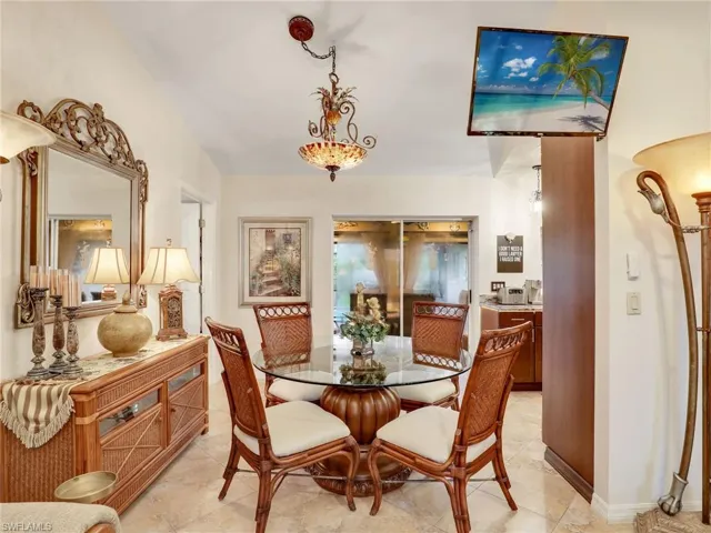 Dining room with view of lanai and pool