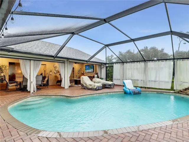 Pavered pool area facing large lanai