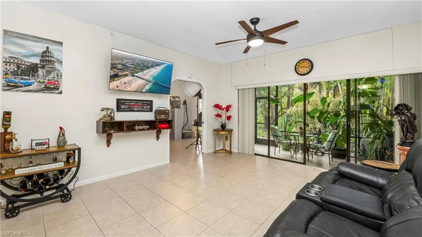 Living area with ceiling fan and light tile patterned floors