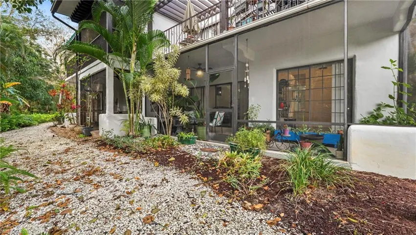 View of exterior entry featuring a sunroom and stucco siding