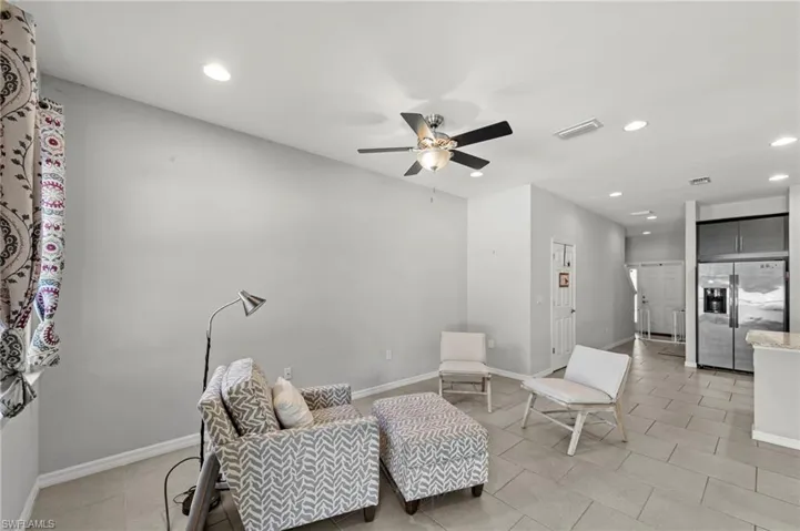 Living area with recessed lighting and a ceiling fan