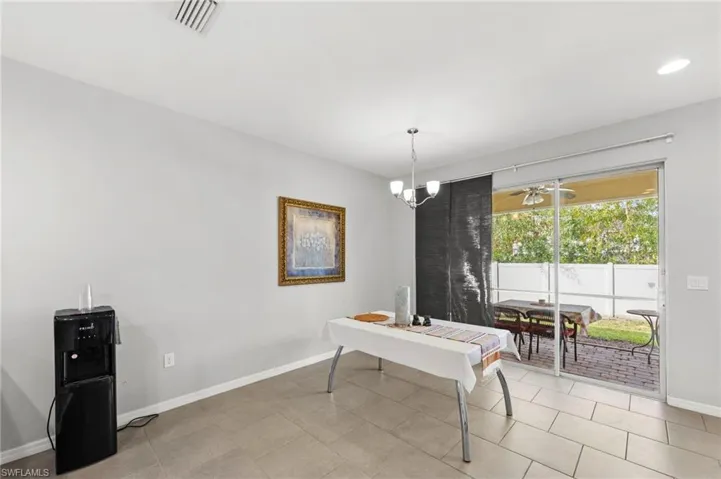 Dining room featuring a chandelier and baseboards