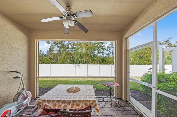 Sunroom / solarium with a ceiling fan and outdoor dining space