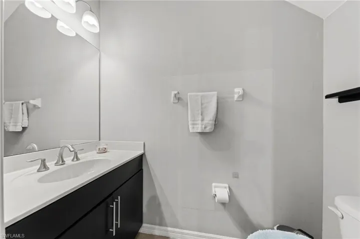 Half bathroom with toilet and vanity